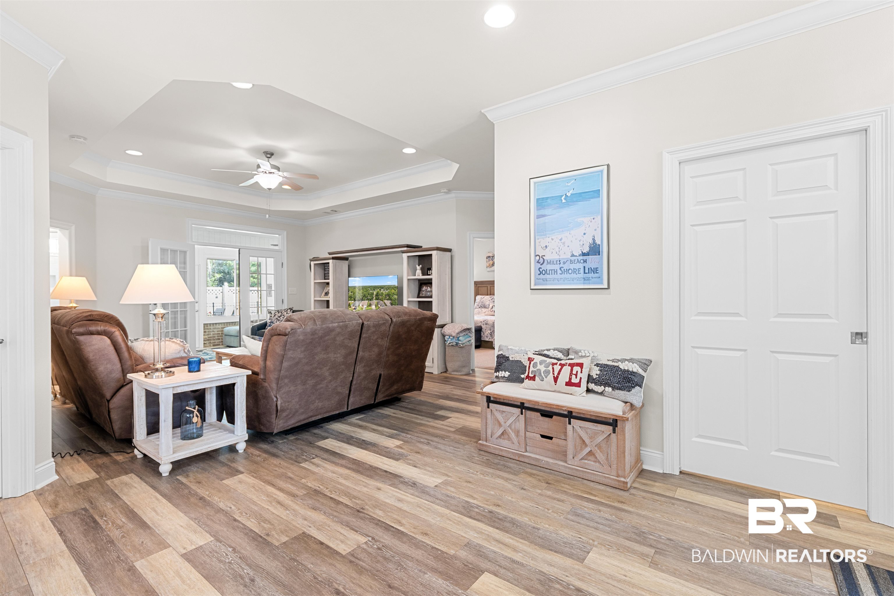 141 Mark Twain Loop Foley, AL 36535 - Photo 14 of 55 Living area featuring a raised ceiling, light wood-type flooring, ceiling fan, ornamental molding, and recessed lighting