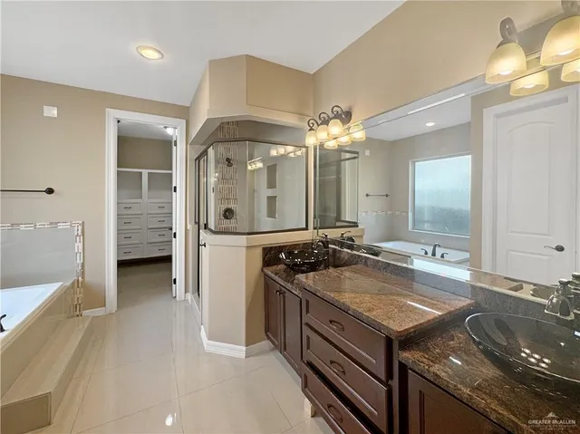 a bathroom with a double vanity sink and a mirror