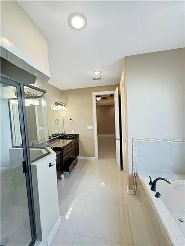 a spacious bathroom with a tub and a sink