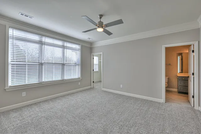 a bed room with a bed and a large window