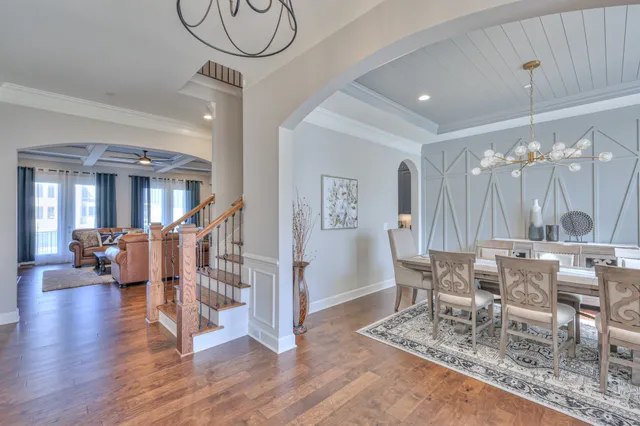 a front view of a house with a large garden and plants