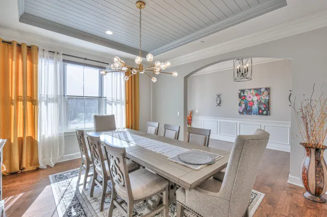 an aerial view of a house with a garden and chairs