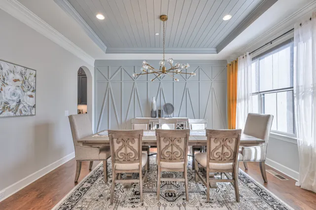 a view of a livingroom with wooden floor and staircase