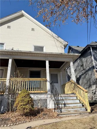 a view of a house with a wooden deck