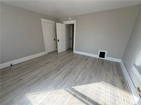 wooden floor in a hall with an empty room