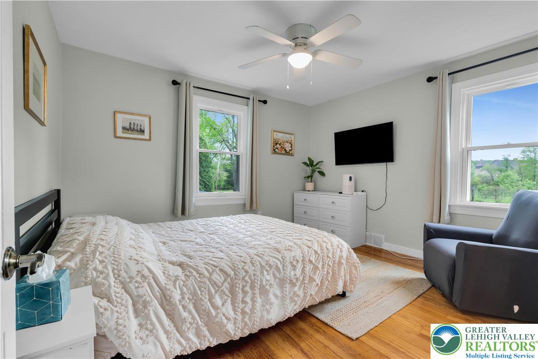 2242 Church Road Bethlehem, PA 18015 - Photo 29 of 74 a bedroom with a bed a couch and a flat screen tv