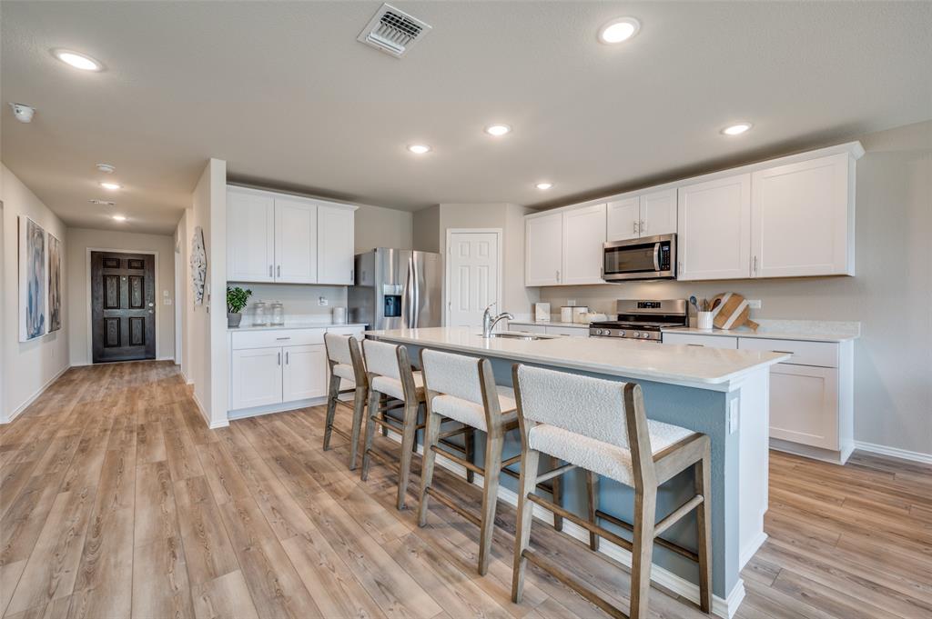 15912 Dauntless Cv Drive Haslet, TX 76052 - Photo 2 of 7 Spacious kitchen with eat-in bartop island *Model Representation*