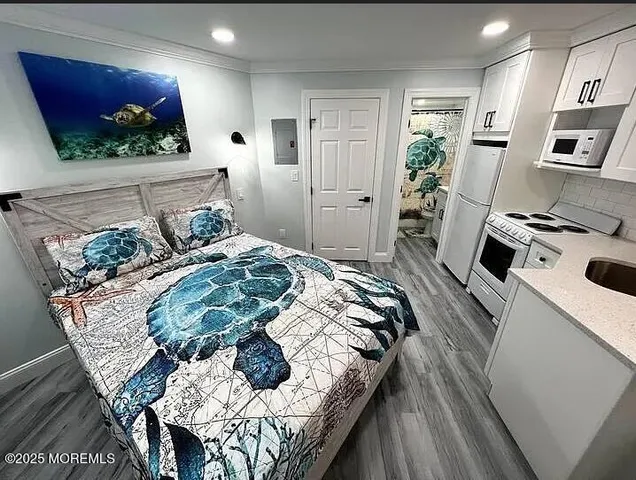 a bed sitting in a kitchen next to a window