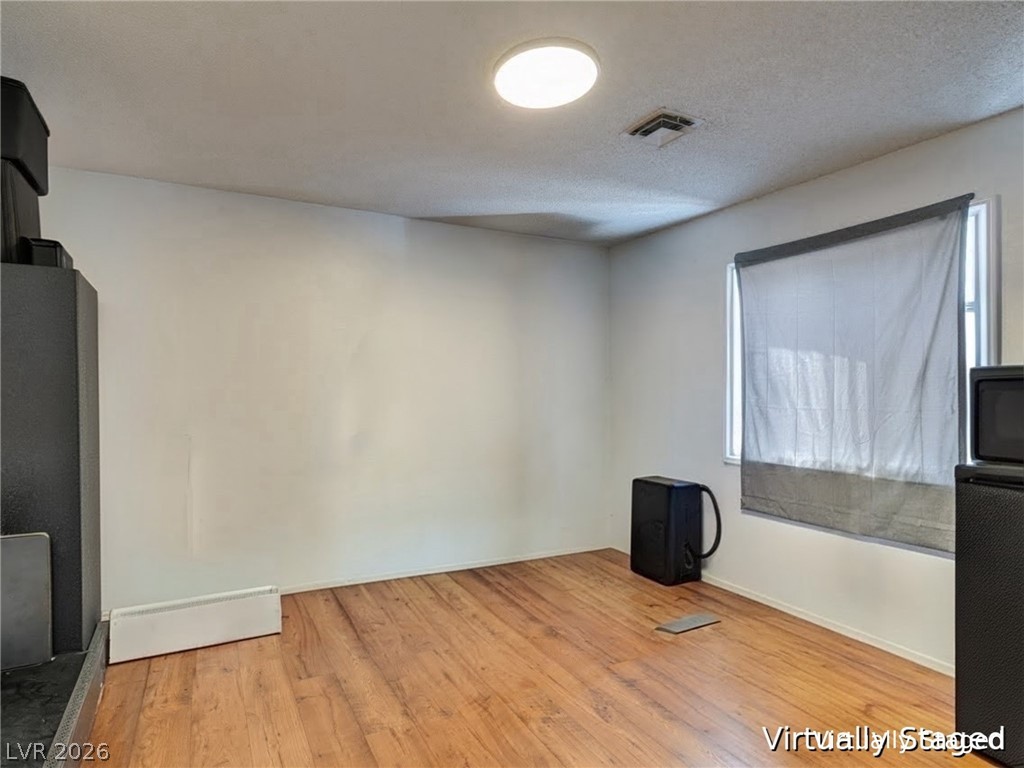 892 North Hollywood Boulevard Las Vegas, NV 89110 - Photo 46 of 81 This versatile room features warm wood flooring and abundant natural light, creating an inviting atmosphere.