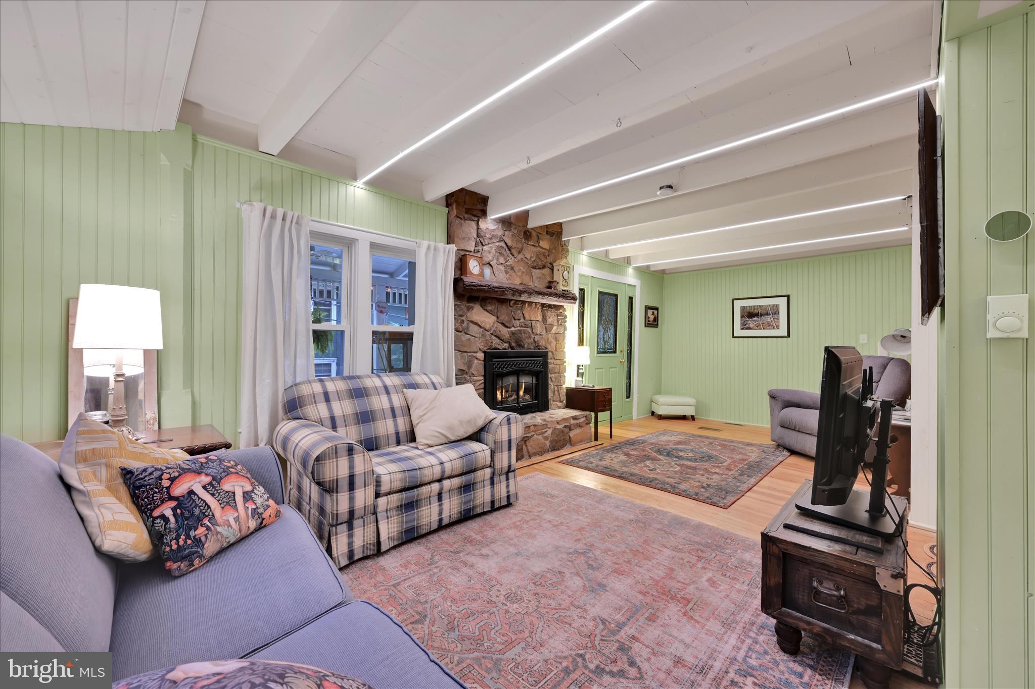 609 6th Street Mount Gretna, PA 17064 - Photo 12 of 39 a living room with furniture fireplace and a large window