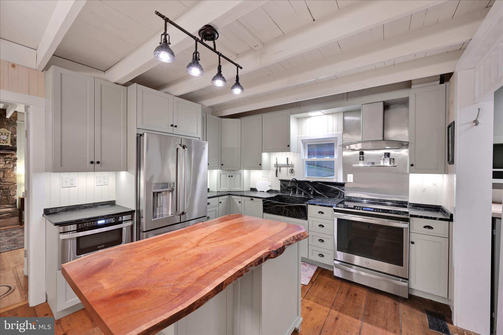 609 6th Street Mount Gretna, PA 17064 - Photo 15 of 39 a kitchen with stainless steel appliances a stove a sink a refrigerator cabinets and chairs