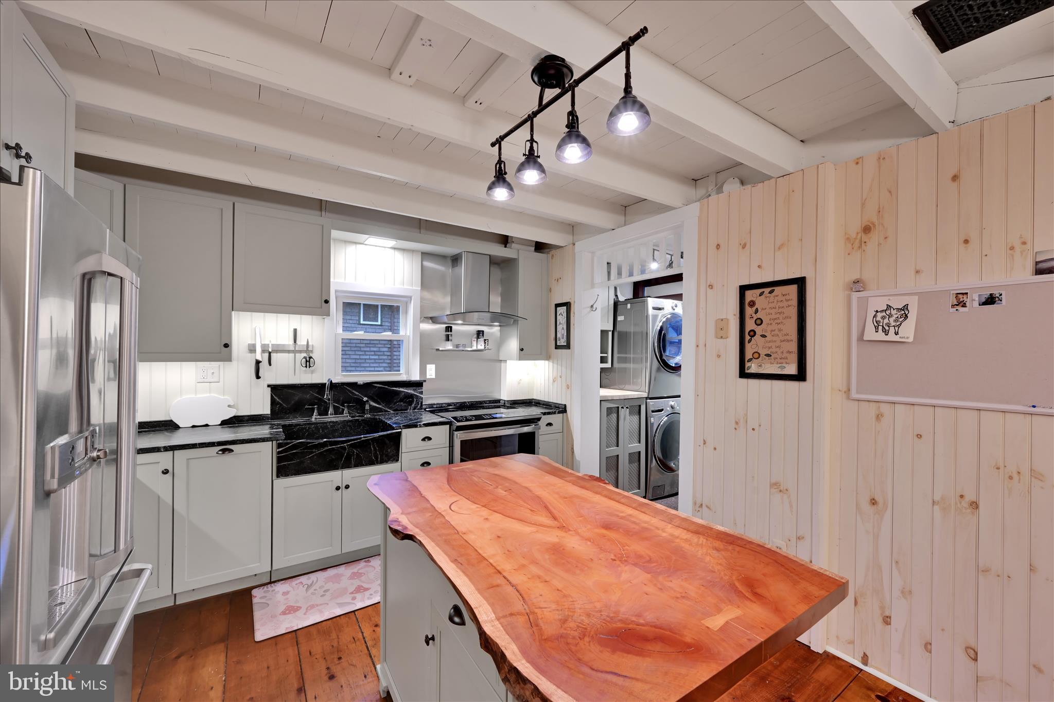 609 6th Street Mount Gretna, PA 17064 - Photo 16 of 39 a kitchen with stainless steel appliances granite countertop a refrigerator a sink dishwasher and white cabinets with wooden floor