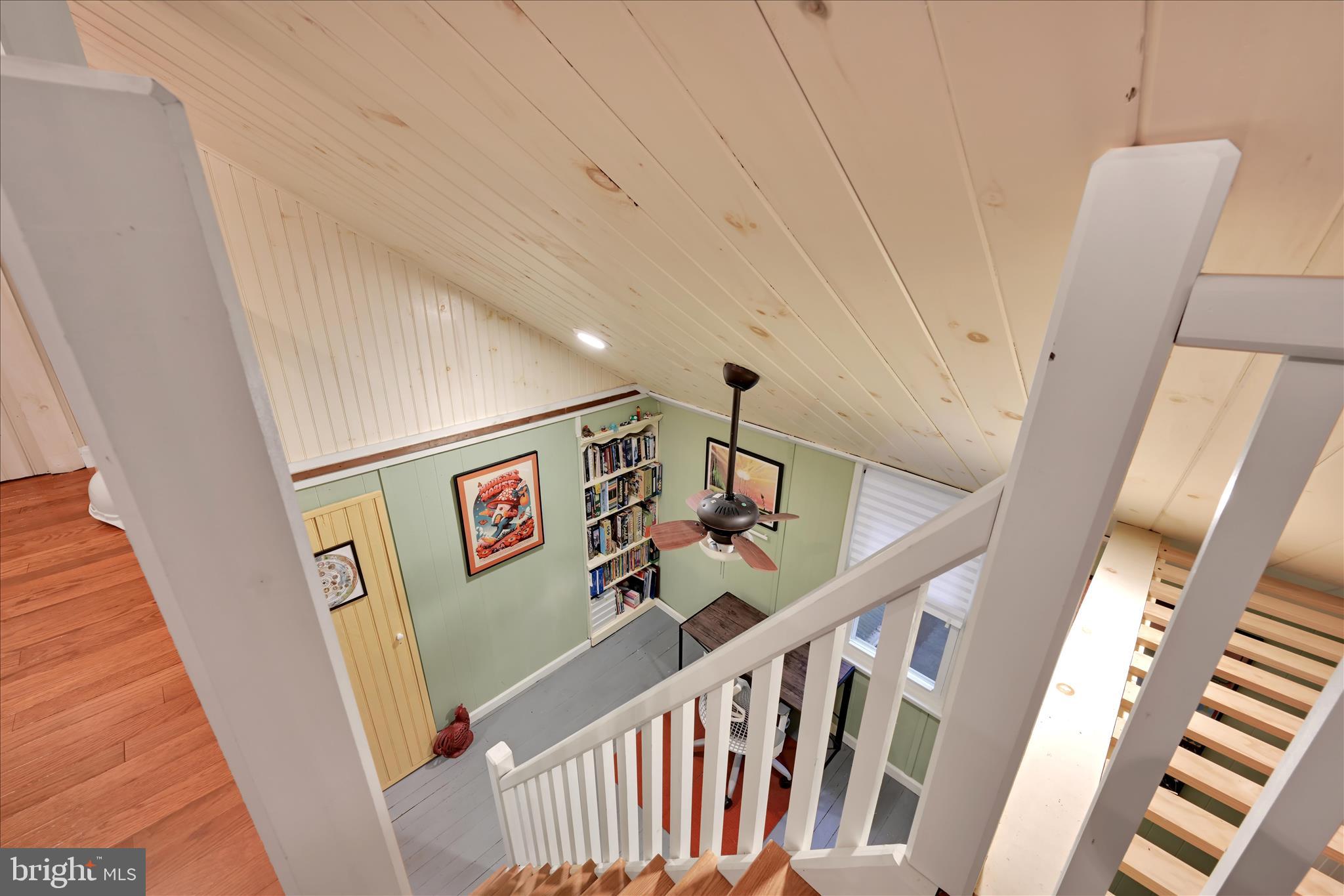 609 6th Street Mount Gretna, PA 17064 - Photo 29 of 39 a view of staircase with lots of frames on wall and wooden floor