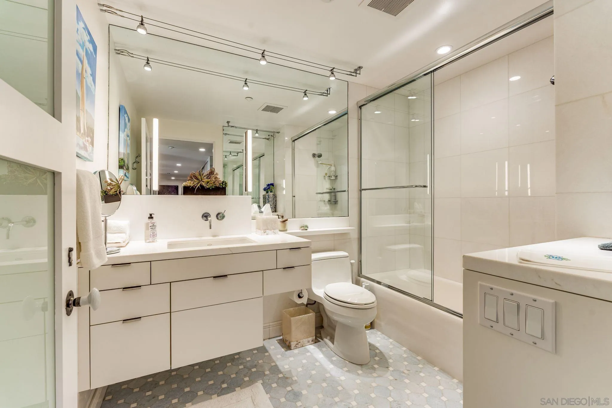 202 Coast Boulevard, Unit 6 La Jolla, CA 92037 - Photo 15 of 22 a bathroom with a sink toilet and shower