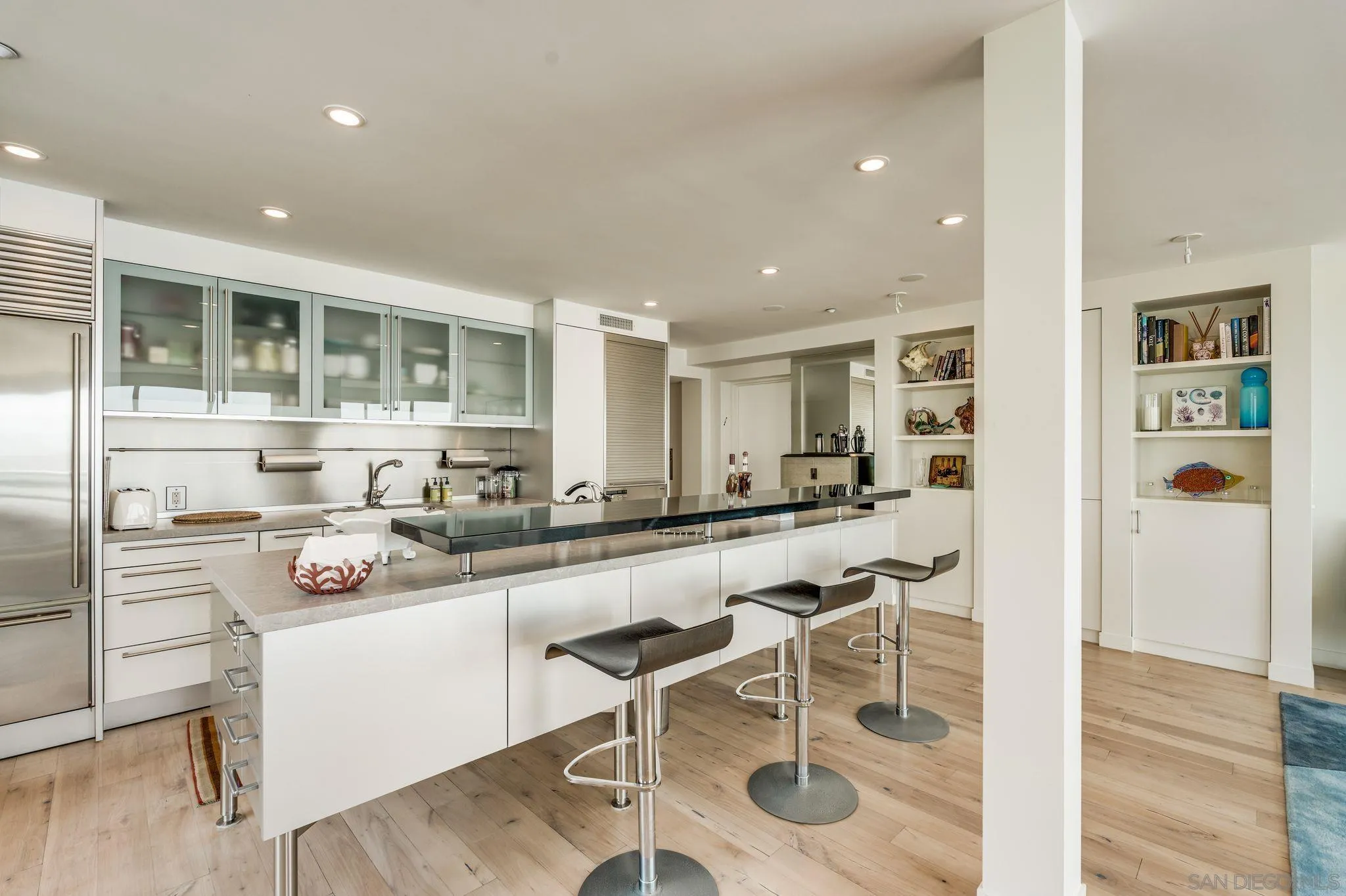 202 Coast Boulevard, Unit 6 La Jolla, CA 92037 - Photo 5 of 22 a kitchen with a sink and chairs