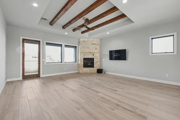 a large kitchen with kitchen island a large counter top stainless steel appliances and cabinets