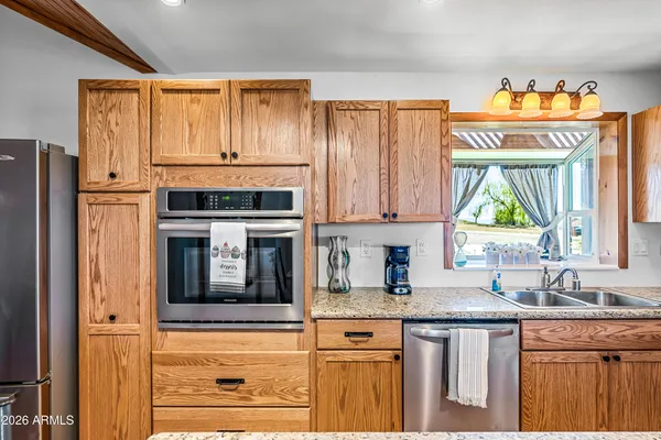 a kitchen with granite countertop a sink and a window