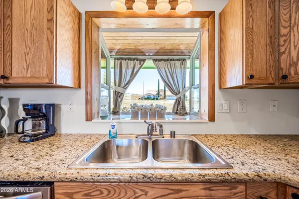 a kitchen with granite countertop a sink and a window