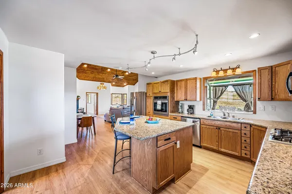 a kitchen with stainless steel appliances granite countertop a sink and cabinets