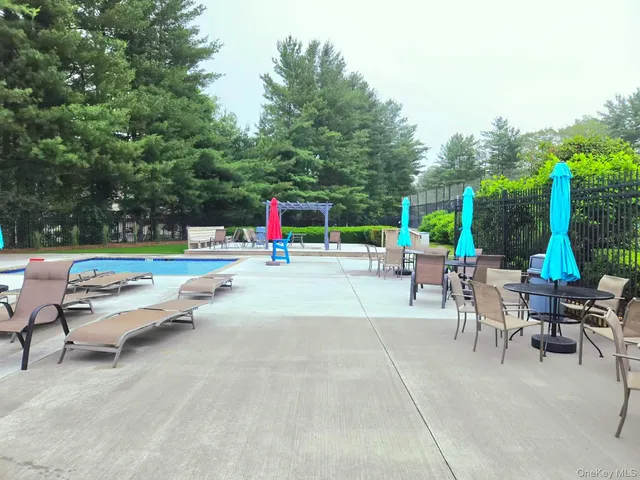 a view of a patio with a table and chairs