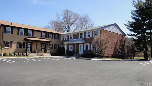 a front view of a building with a yard
