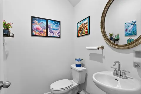 a bathroom with a toilet a sink and a mirror