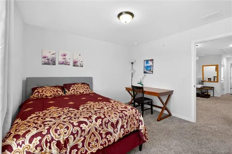 a bedroom with a bed and a desk