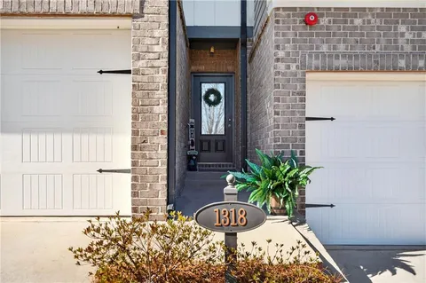 a vase of flowers sitting on a table in front of a door