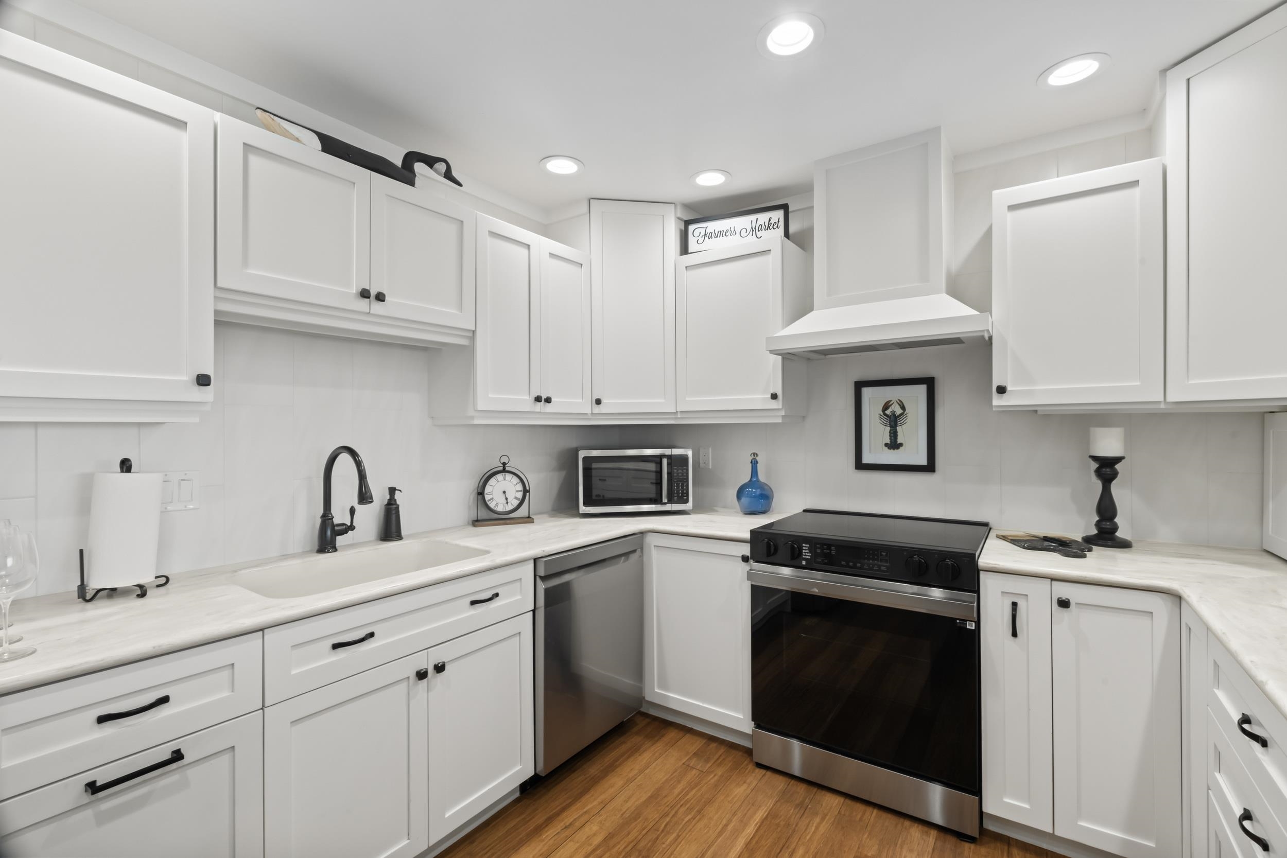 3431 Harbor Drive St. Augustine, FL 32084 - Photo 22 of 61 a kitchen with granite countertop a sink a stove and cabinets