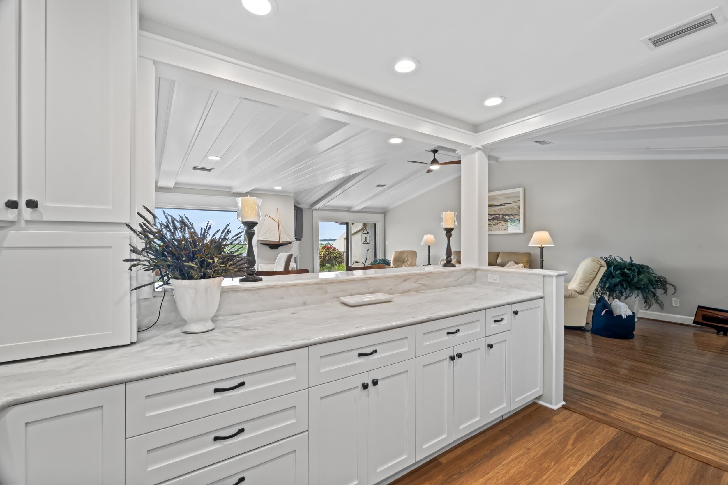 3431 Harbor Drive St. Augustine, FL 32084 - Photo 24 of 61 a bathroom with a granite countertop sink a potted plant and a large mirror