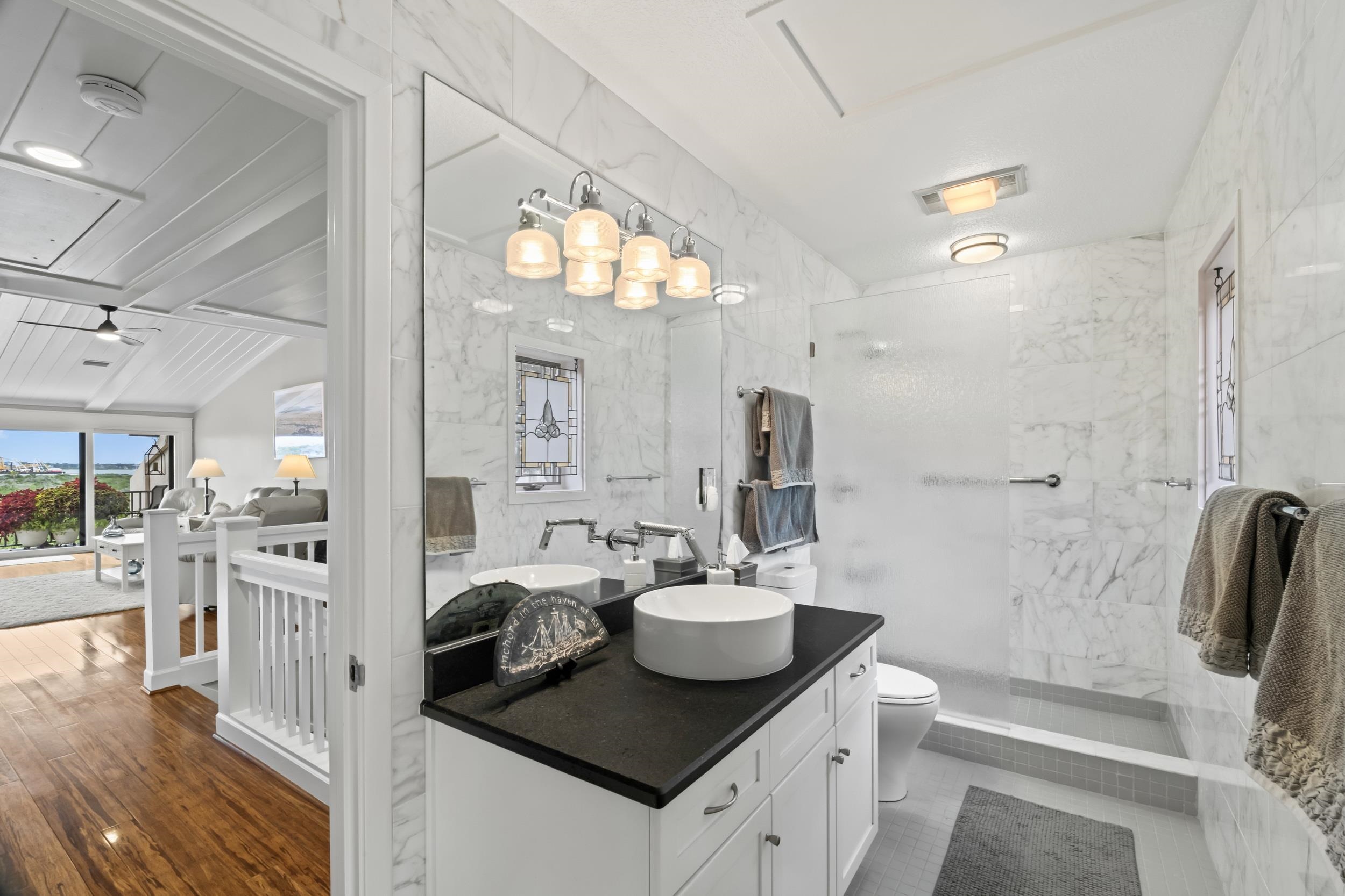 3431 Harbor Drive St. Augustine, FL 32084 - Photo 27 of 61 a bathroom with a sink a toilet and shower