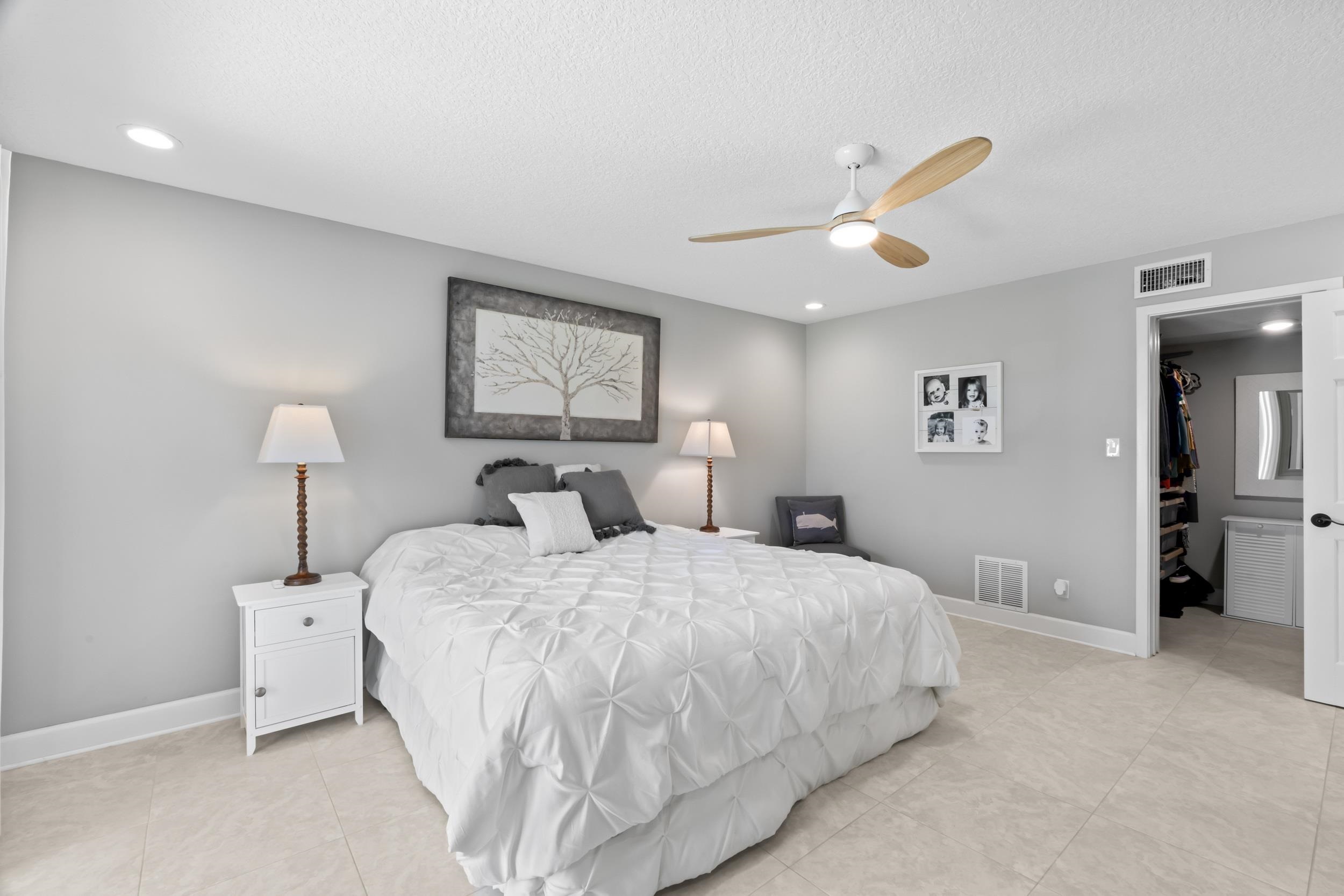 3431 Harbor Drive St. Augustine, FL 32084 - Photo 36 of 61 a bedroom with bed and a chandelier