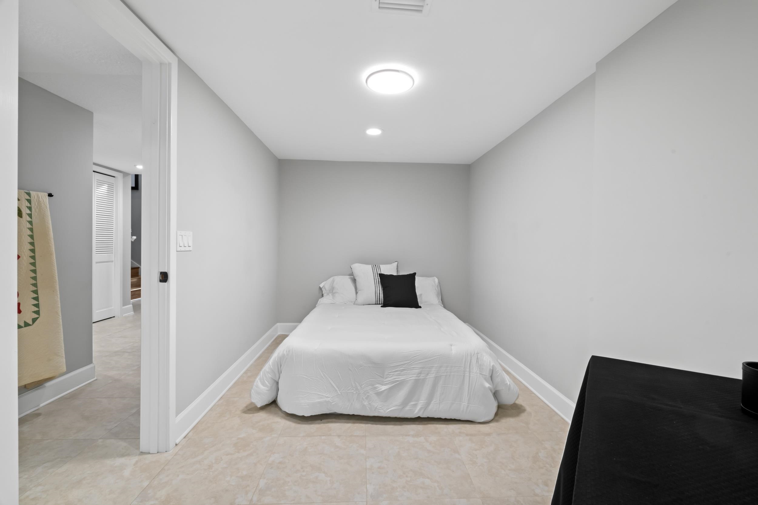 3431 Harbor Drive St. Augustine, FL 32084 - Photo 45 of 61 a bedroom with a bed and a night stand