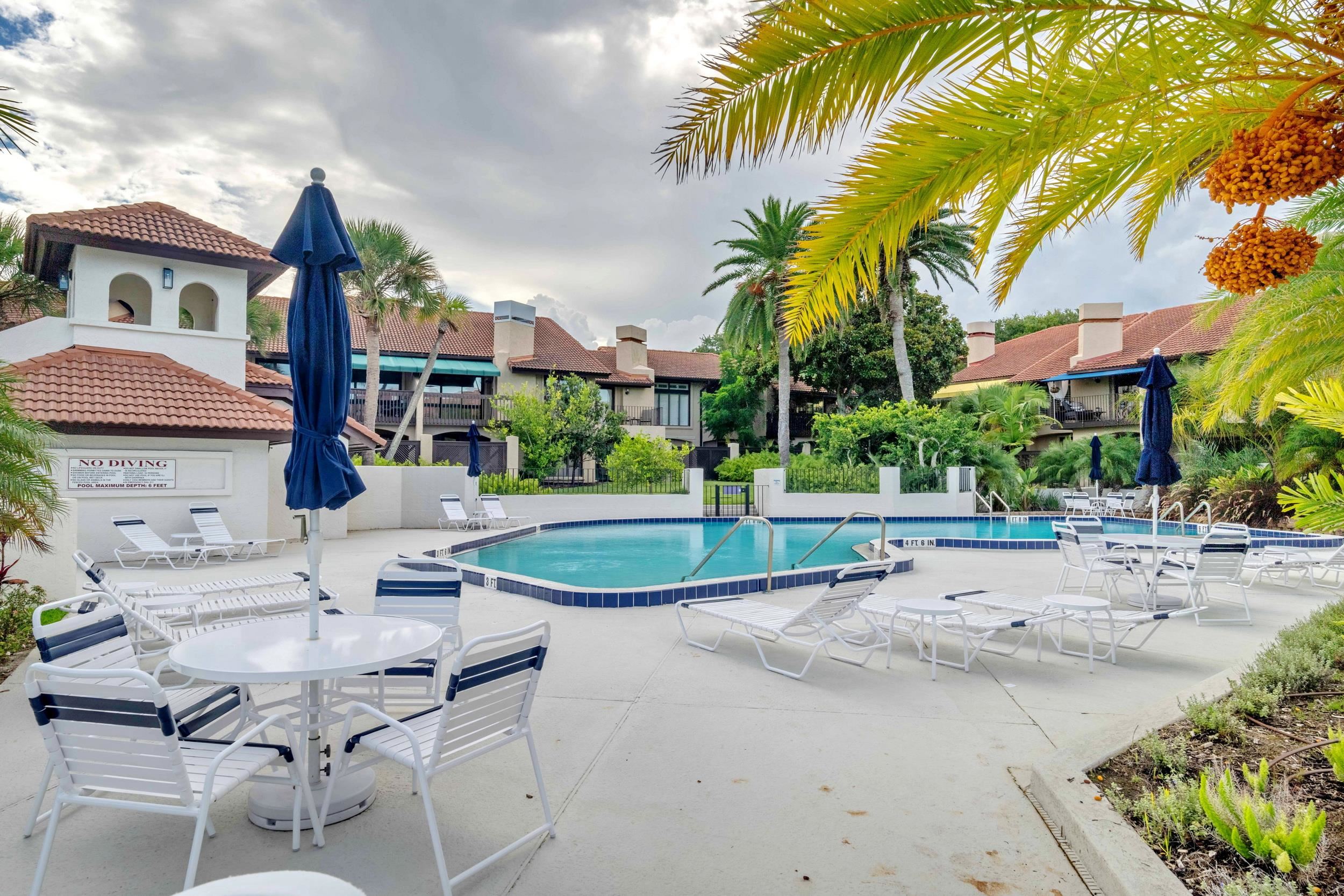 3431 Harbor Drive St. Augustine, FL 32084 - Photo 59 of 61 a view of a house with a swimming pool and a lawn chairs under palm trees