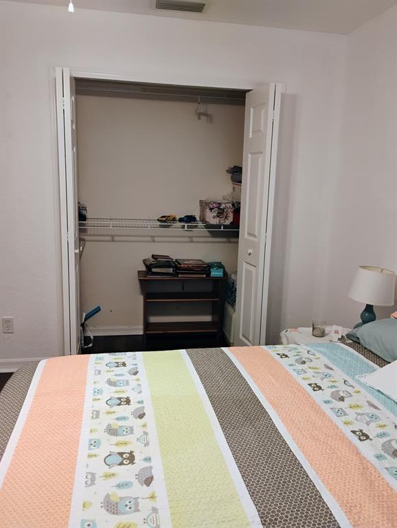 14441 Dulce Real Avenue Fort Pierce, FL 34951 - Photo 15 of 23 a bedroom with a bed and a dresser