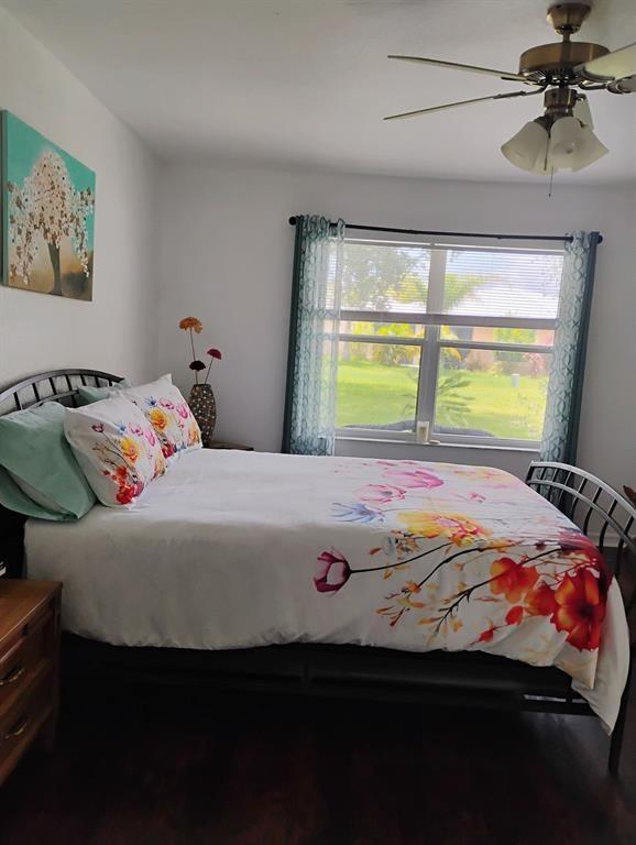 14441 Dulce Real Avenue Fort Pierce, FL 34951 - Photo 21 of 23 a bedroom with a bed and a chandelier