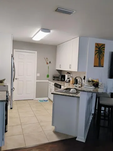 a kitchen with stainless steel appliances granite countertop a sink and cabinets