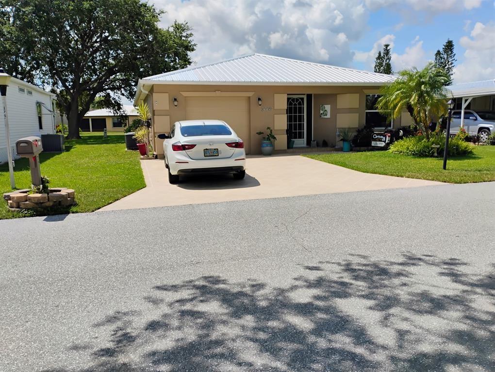 14441 Dulce Real Avenue Fort Pierce, FL 34951 - Photo 23 of 23 a car parked in front of a white house