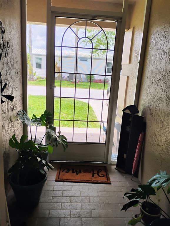 14441 Dulce Real Avenue Fort Pierce, FL 34951 - Photo 3 of 23 a living room with furniture and a floor to ceiling window