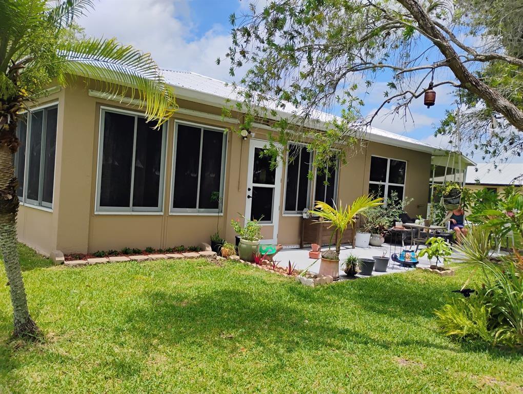 14441 Dulce Real Avenue Fort Pierce, FL 34951 - Photo 5 of 23 a view of a house with a backyard and sitting area