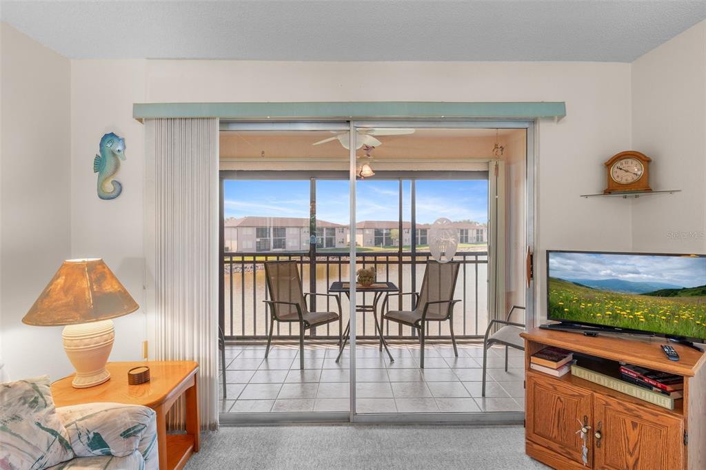 25100 Sandhill Boulevard, Unit R202 Punta Gorda, FL 33983 - Photo 11 of 39 a room with a wooden floor and a table chair