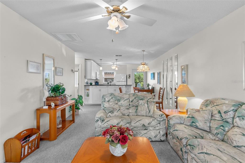 25100 Sandhill Boulevard, Unit R202 Punta Gorda, FL 33983 - Photo 12 of 39 a living room with furniture and a chandelier