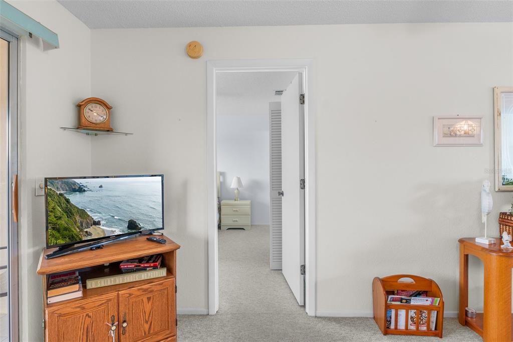 25100 Sandhill Boulevard, Unit R202 Punta Gorda, FL 33983 - Photo 13 of 39 a room with furniture and screen on the wall