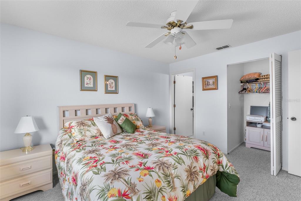 25100 Sandhill Boulevard, Unit R202 Punta Gorda, FL 33983 - Photo 16 of 39 a bedroom with a bed and a chandelier