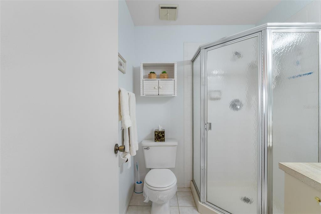 25100 Sandhill Boulevard, Unit R202 Punta Gorda, FL 33983 - Photo 23 of 39 a bathroom with a toilet and a shower