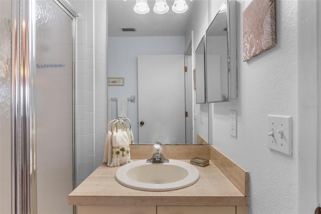 25100 Sandhill Boulevard, Unit R202 Punta Gorda, FL 33983 - Photo 24 of 39 a bathroom with a sink and a mirror