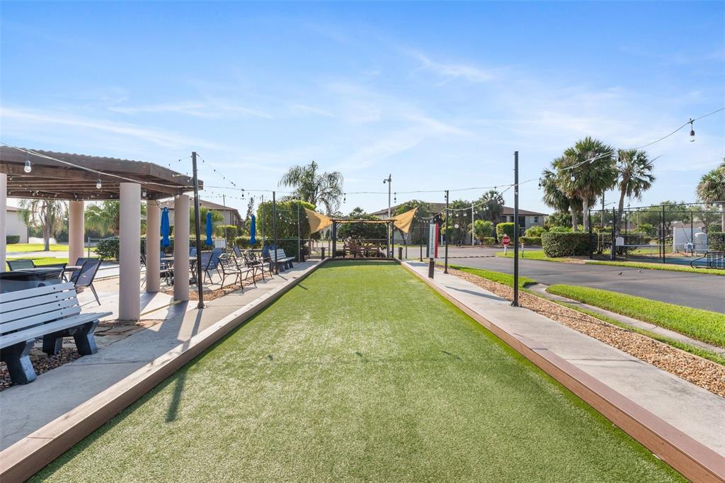 25100 Sandhill Boulevard, Unit R202 Punta Gorda, FL 33983 - Photo 28 of 39 a swimming pool with outdoor seating and yard