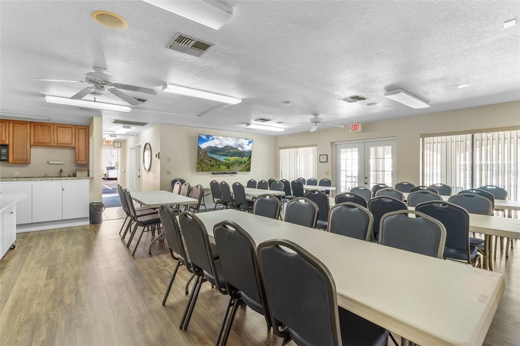 25100 Sandhill Boulevard, Unit R202 Punta Gorda, FL 33983 - Photo 30 of 39 a living room with lots of white furniture and window