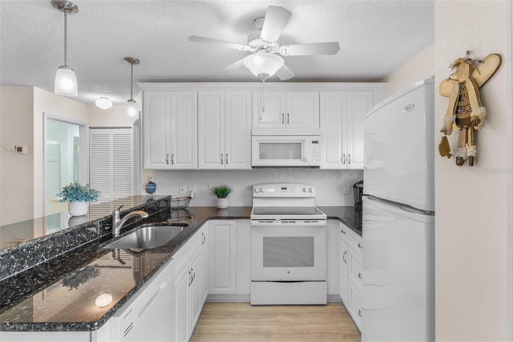 25100 Sandhill Boulevard, Unit R202 Punta Gorda, FL 33983 - Photo 4 of 39 a kitchen with a sink appliances and cabinets