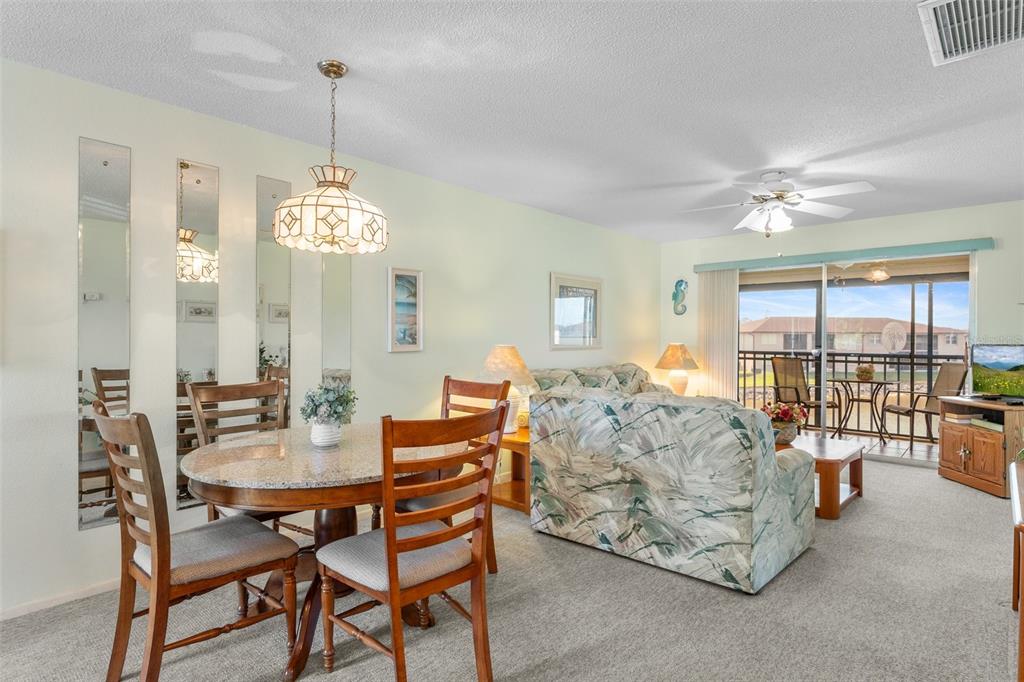 25100 Sandhill Boulevard, Unit R202 Punta Gorda, FL 33983 - Photo 7 of 39 a view of a dining room with furniture window and outside view